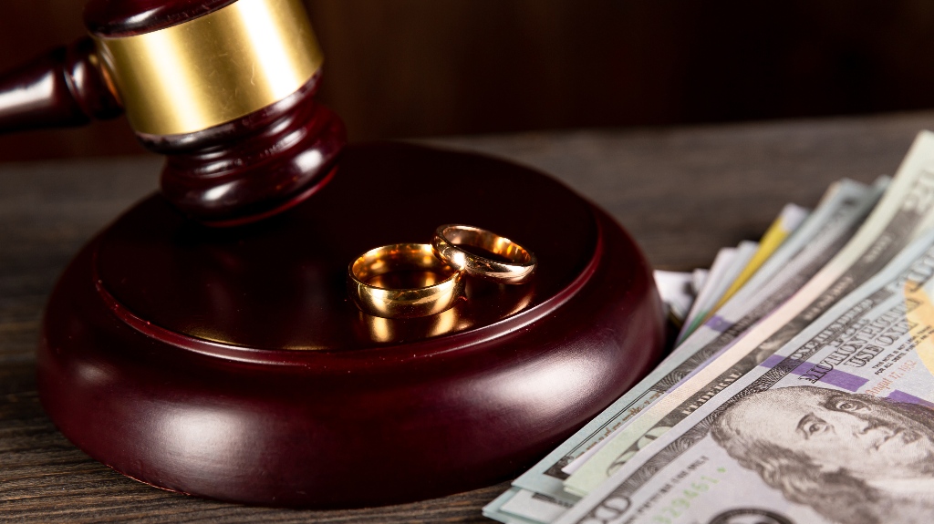 Judge's gavel and wedding ring with money