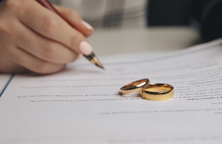 Woman is signing divorce document