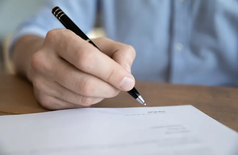 Man is signing documents