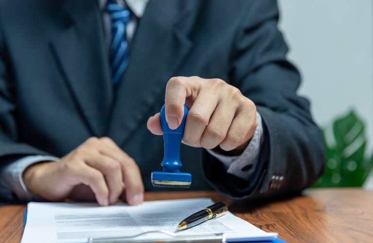 lawyer is putting stamp in the document