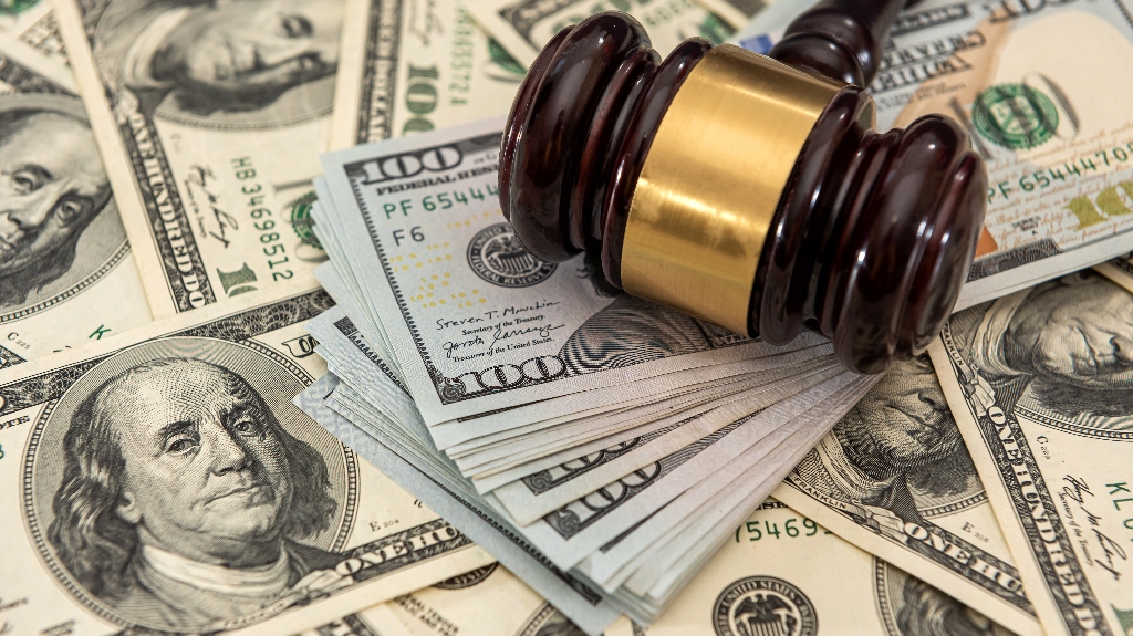 Money with gavel on top